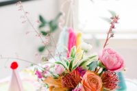 30 a bright and cool floral wedding centerpiece wiht greenery and pastel and bright pompoms on the wall is amazing to add fun and color