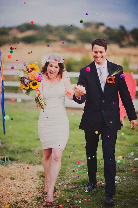 use colorful pompoms for your wedding exit instead of rice, petals and other stuff and make your exit fun and bold