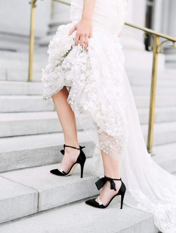 a refined lace mermaid wedding dress with a train, black wedding shoes with embellishments for a stylish and sexy look