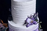 32 an ombre white to purple wedding cake topped with purple blooms, with blackberries and blueberries is a bold and cool idea for your wedding
