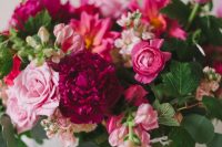 33 a lush and dimensional wedding centerpiece of fuchsia and hot pink blooms, light pink flowers and greenery for a bright wedding