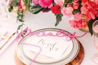 35 a pretty glam wedding tablescape with light and hot pink blooms, wodoen placemats and pink calligraphy cards, with gold cutlery