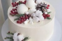 36 a buttercream wedding cake topped with berries, greenery, snowballs and pinecones plus masrhmallows