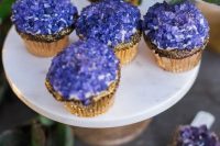 38 fantastic cupcakes with violet sugar geodes on top and gold glitter are great for your wedding dessert table, a nice addition for a purple cake