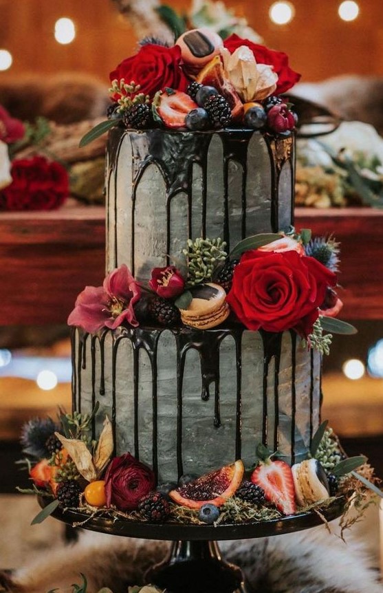 a decadent fall wedding cake in grey, with chocolate drizzle, bright blooms, citrus, berries and greenery