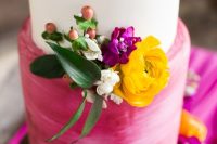 41 a bright wedding cake with a white and brushstroke hot pink wedding cake with berries, a yellow, a fuchsia and white bloom, greenery