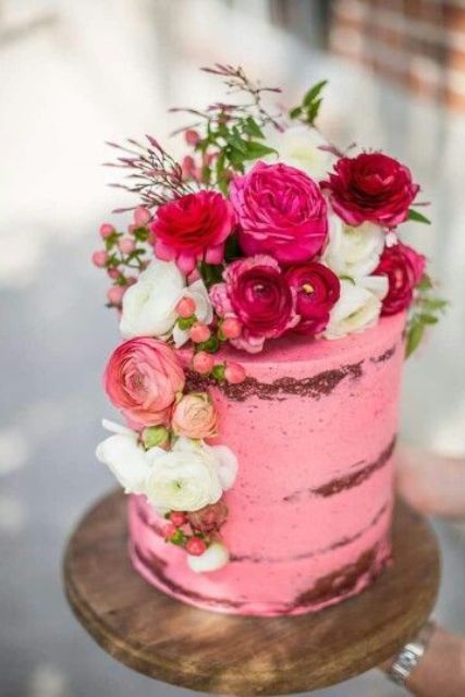 a pretty hot pink wedding cake with a bit of frosting, with hot pink and white blooms, berries and a bit of greenery is cool for your wedding