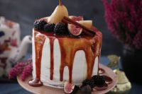 46 a white wedding cake with caramel drip, fresh berries and fruit, with cinnamon sticks is a delicious idea for a fall wedding, a boho and not only