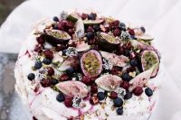 51 a catchy pavlova wedding cake topped with fresh fruits and berries, some blooms and nuts is fantastic