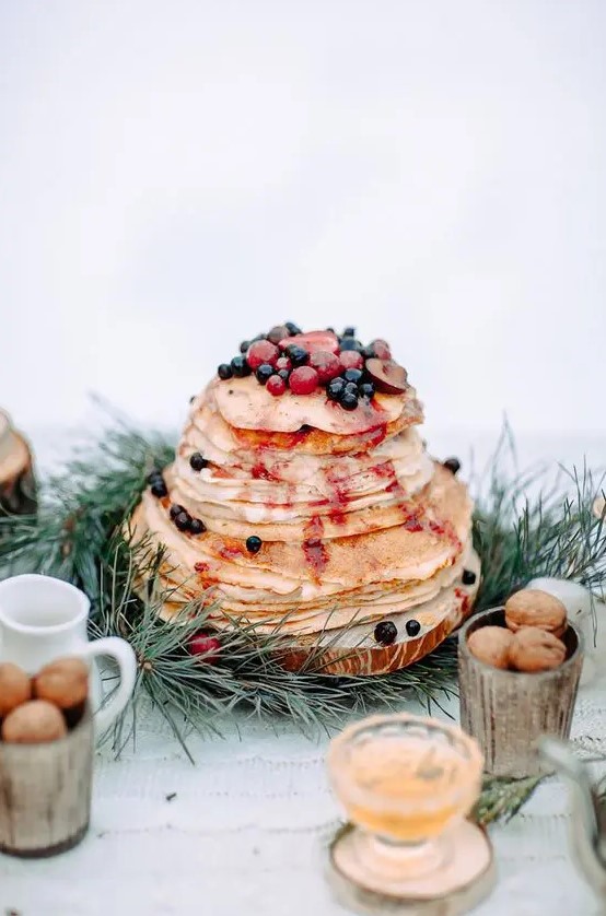 a crepe wedding cake with berry sauce and fresh berries and fruit on top is a lovely idea for a decadent fall wedding
