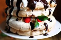 57 a pavlova cake with chocolate, raspberries, leaves and some drip is a delicious idea that everybody will enjoy
