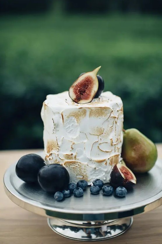 a small meringue wedding cake topped with fresh figs, with berries and pears is amazing for a fall wedding