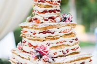 64 a waffle wedding cake with strawberries, thistles and pink roses plus sugar powder looks delicious