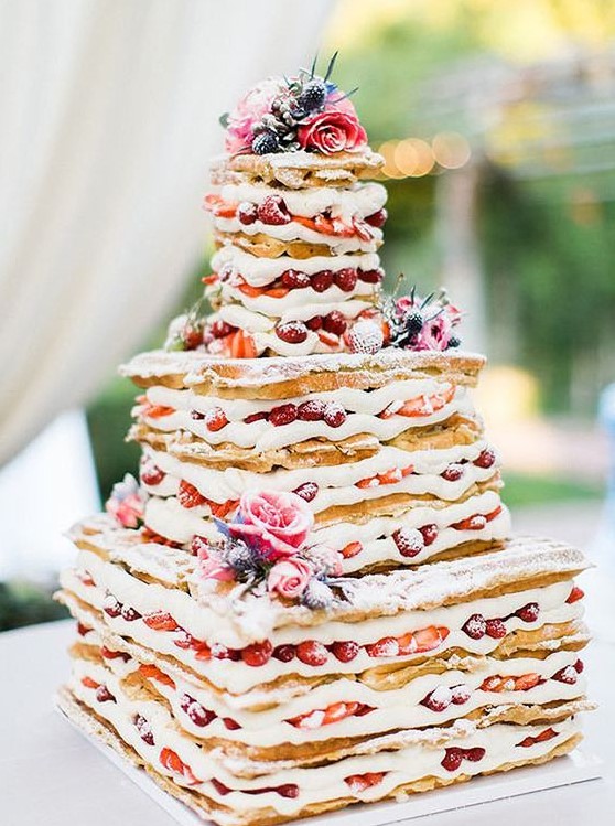 a waffle wedding cake with strawberries, thistles and pink roses plus sugar powder looks delicious