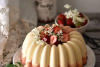 65 a white and pink bundt wedding cake with white blooms and fresh strawberries inside and on top is gorgeous