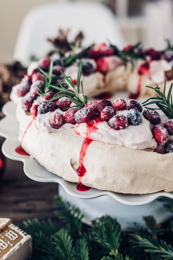 a Christmas pavlova wedding cake or wreath with whipped cream, cranberries and herbs plus drip is a gorgeous idea for a winter or Christmas wedding