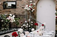 a cool modern wedding tablescape with neutral linens, white, blush and red roses and a bit of candles is amazing and easy to recreate