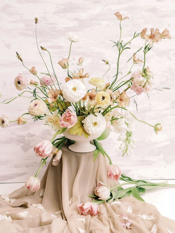 a fine art wedding centerpiece of blush, yellow and white ranunculus and some tulips is a fantastic idea to rock