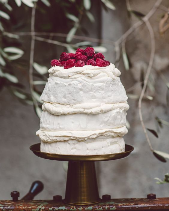a meringue wedding cake with creamy and fresh raspberries on top is a fantastic and easy to recreate idea for a summer wedding