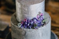 a modern wedding cake with a silver and a grey tier, with purple blooms and succulents is a very stylish idea inspired by concrete