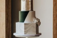a multi-tier wedding cake with a marble, color block, silver leaf and ombre tiers, with white blooms is dramatic and extra bold