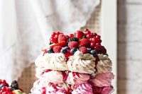 a pavlova wedding cake of three tiers – a hot pink, light pink and white one, with lots of delicious berries and berry drip for a summer wedding