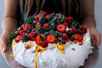 a pavlova wedding cake with caramel drip, blackberries, blueberries, strawberries and plums is a lovely idea for a fall wedding