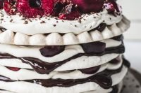 a pavlova wedding cake with chocolate drip, fresh cherries and chocolate on top is a lovely idea for a summer or fall wedding