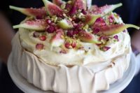 a pavlova wedding cake with fresh pomegranates and figs plus nuts on top is a lovely idea for a fall wedding