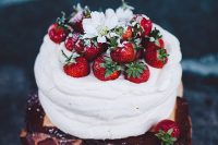 a pavlova wedding cake with strawberries and white blooms and sugar on top is a fantastic idea for a summer wedding