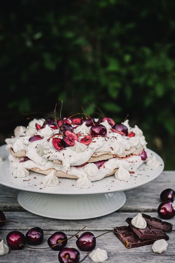 a vegan black forest pavlova meringue cake is a beautifully crispy, fluffy and sweet cake for summer filled with cream, chocolate and cherries