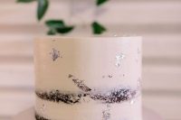a naked wedding cake decorated with silver leaf is a stylish idea for a modern wedding