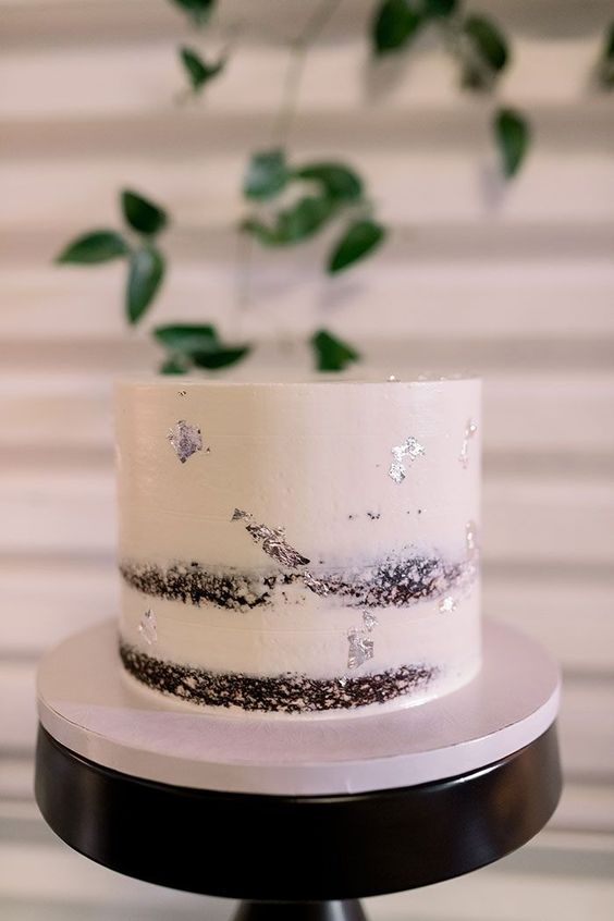 a naked wedding cake decorated with silver leaf is a stylish idea for a modern wedding