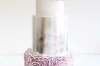 a refined and girlish wedding cake done with a white, silver and pale pink layers and some sugar blooms on top