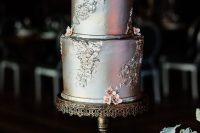 a refined vintage silver leaf wedding cake decorated with blooms and patterns is adorable for a wedding