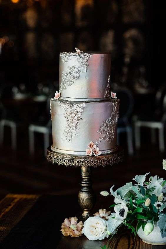 a refined vintage silver leaf wedding cake decorated with blooms and patterns is adorable for a wedding