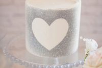 a silver glitter wedding cake with a heart outline is a cool idea for a small glam wedding with a touch of shine