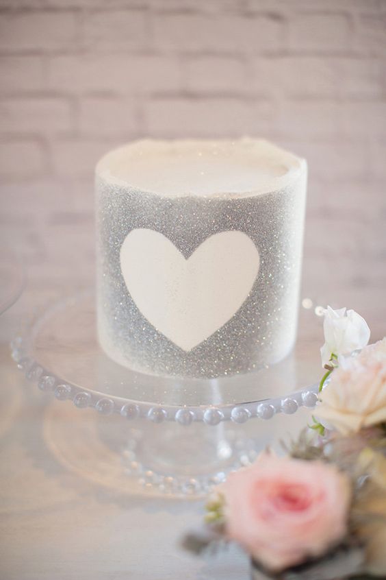 a silver glitter wedding cake with a heart outline is a cool idea for a small glam wedding with a touch of shine