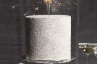 a silver glitter wedding cake with sparklers is a super cool and fun idea for a NYE wedding or pre-wedding party