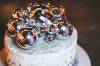 a texture wedding cake with silver beads and silver glitter on top plus some disco balls is amazing for a NYE wedding