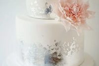 a white wedding cake with distressed silver leaf ans sugar pink dahlia is a cool solution with a touch of shine