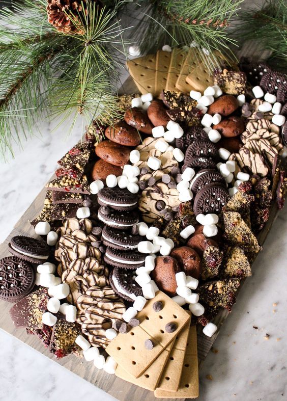 a gorgeous gluten free dessert board using tons of delicious store bought gluten free cookies and desserts, lots of chocolate and marshmallows is amazing