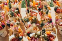 amazing charcuterie cones with salami, olives, berries, edible blooms, cheese and dried fruit are fantastic for a wedding