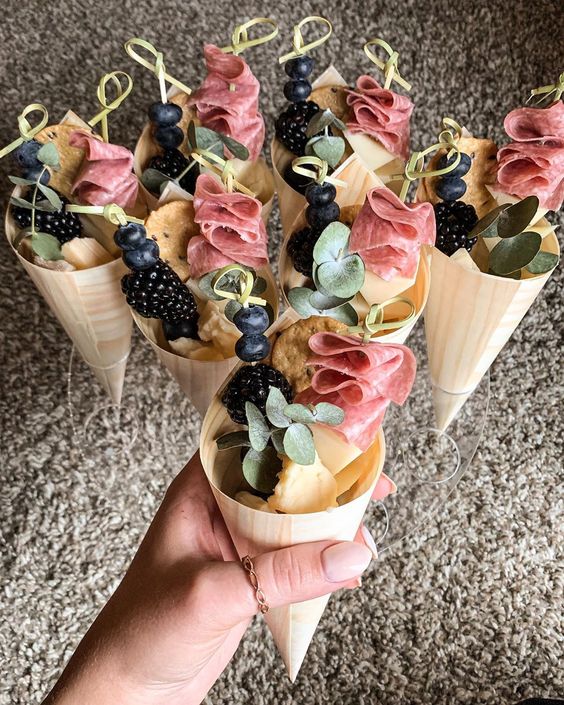 dreamy charcuterie cones with fresh berries, cheese, ham, eucalyptus and crackers are a cool idea for a wedding