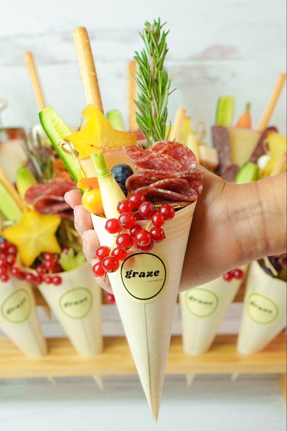 grazing cones with fresh berries and fruits, with herbs and cookies, salami and ham are amazing for a wedding