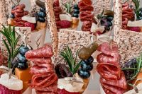 mouth-watering charcuterie cups with sesame cookies, salami and ham, cheese, berries, pickles and some herbs are gorgeous for a wedding