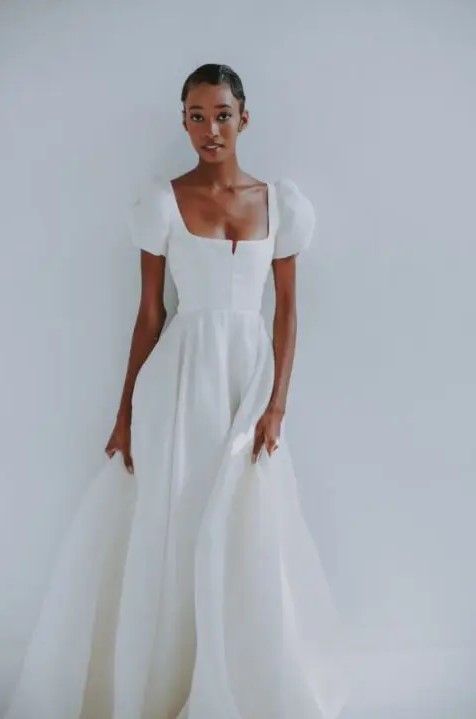 a beautiful A-line plain wedding dress with a square neckline and puff sleeves for a modern romantic bride