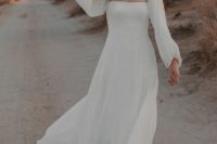 09 a beautiful and flowy A-line plain wedding dress with a square neckline and puff sleeves, a flowy skirt with a train will make your look dreamy and romantic