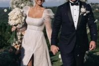 12 a chic modern A-line wedding dress, fully embellished, with a square neckline and puff sheer sleeves and a slit is amazing