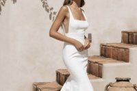 19 a minimalist plain mermaid wedding dress with a square neckline, sheer inserts on the sides, a train for an edgy bridal look